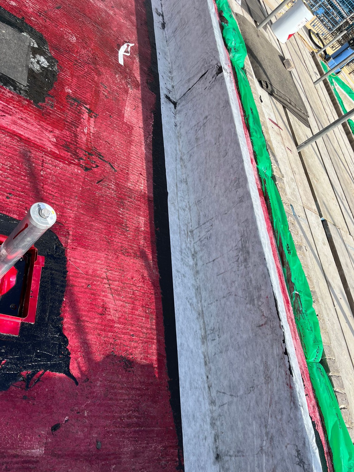 Close-up of reinforced waterproofing at an upstand.