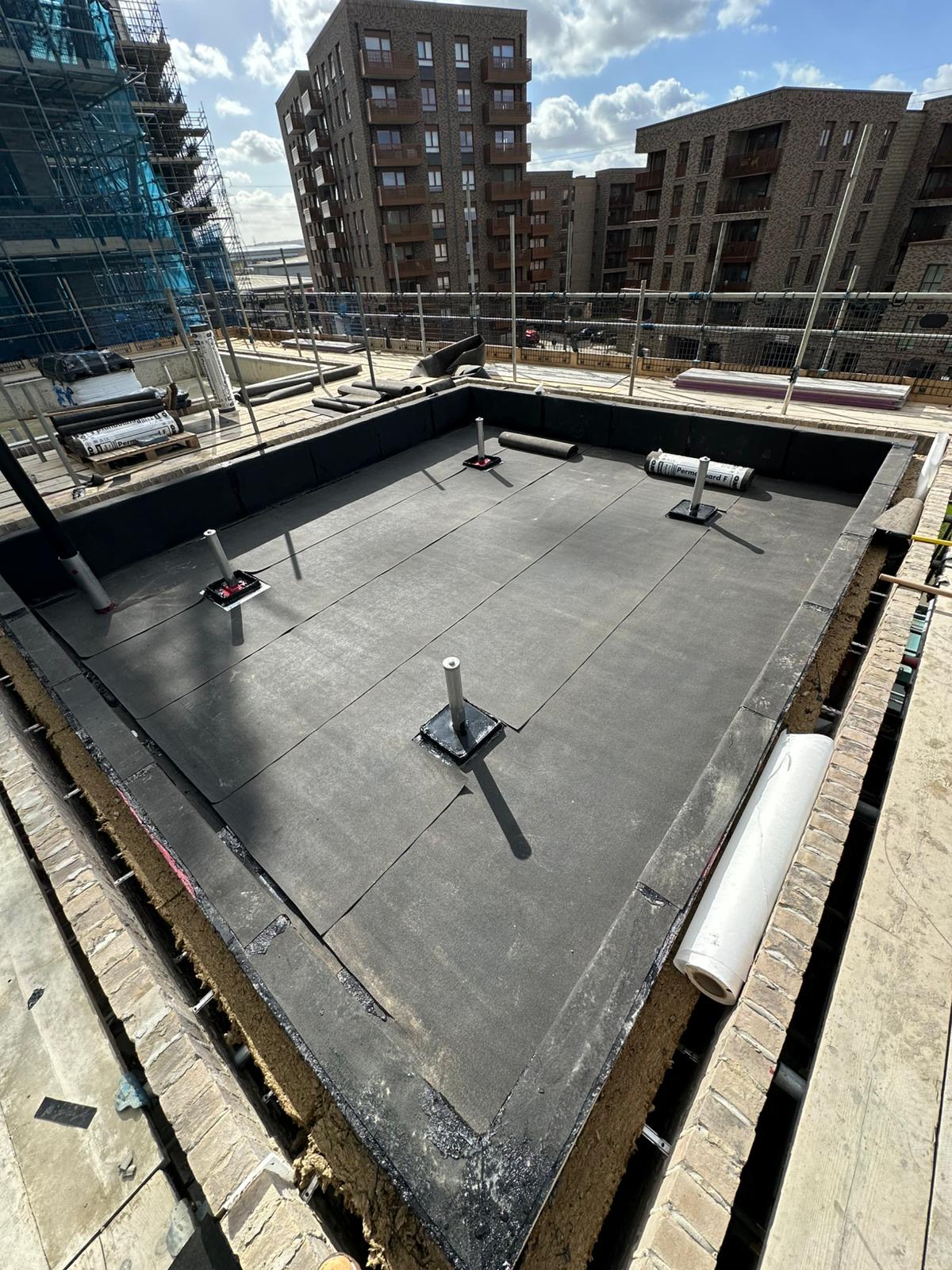 The cut membrane layer fitted across the waterproofed area.